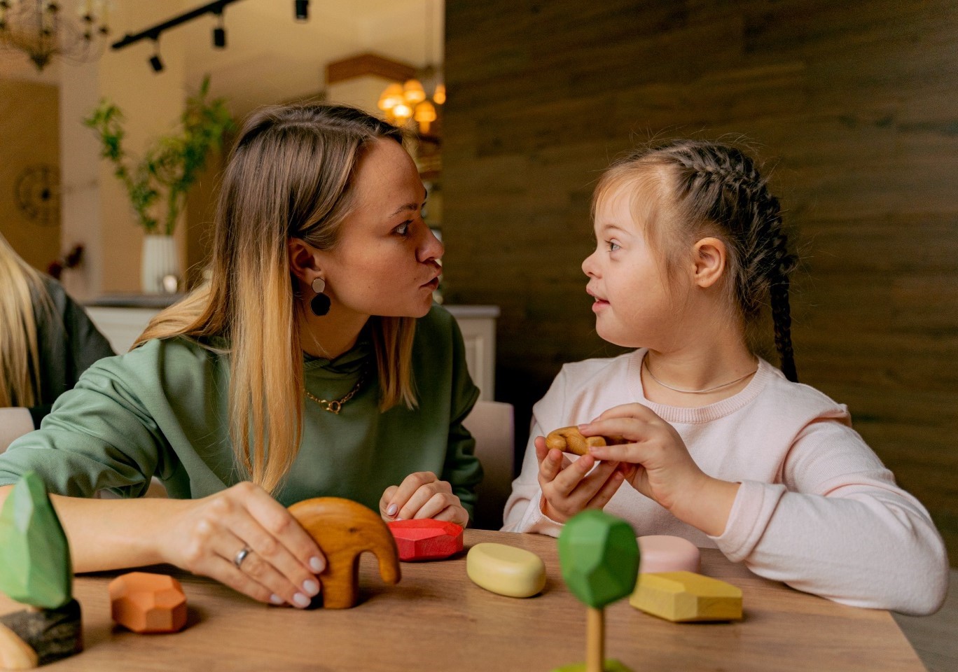 A child with SEND is playing with their carer
