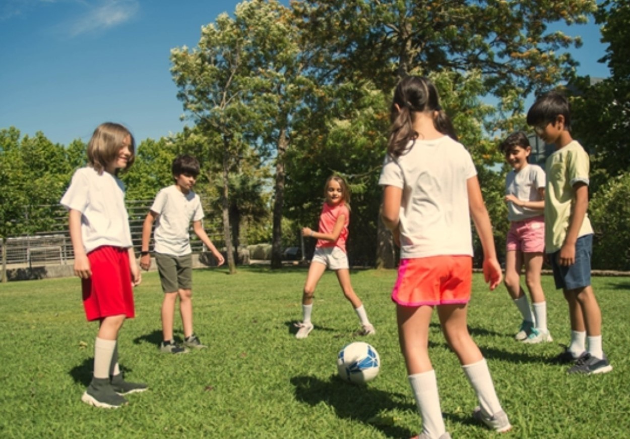 A group of children are playing football