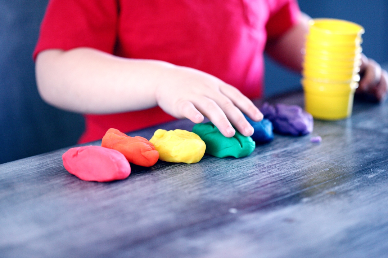 A child is playing with Play-Doh