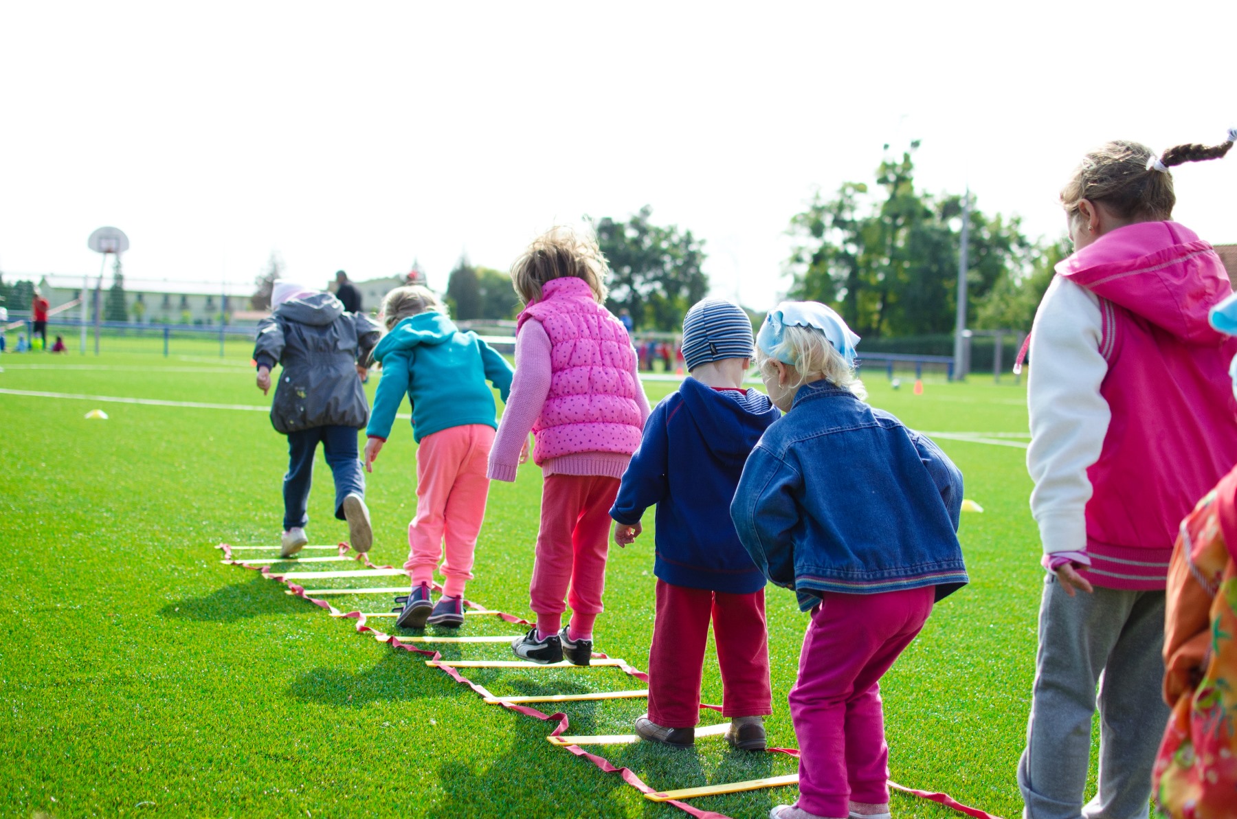 Children are playing in a sports field