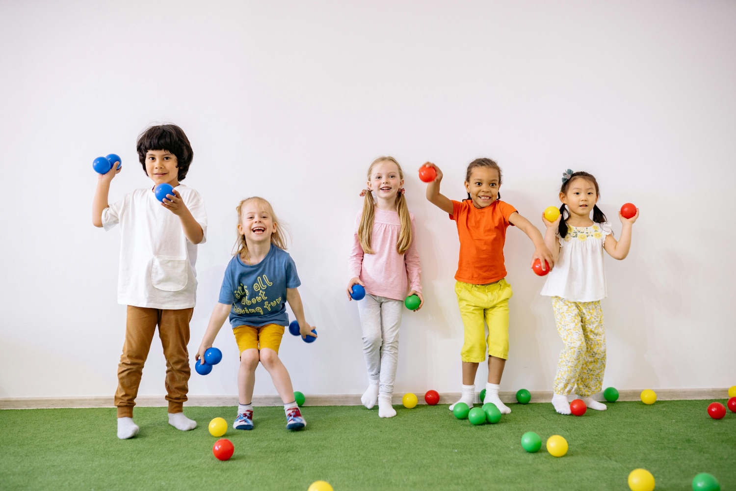 Children are playing with multicoloured toy balls